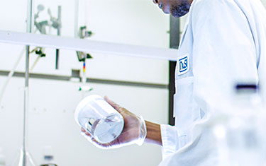 NuSil technician inspecting silicone-filled container
