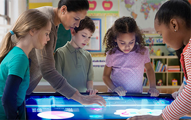 Children using large digital touchscreen display